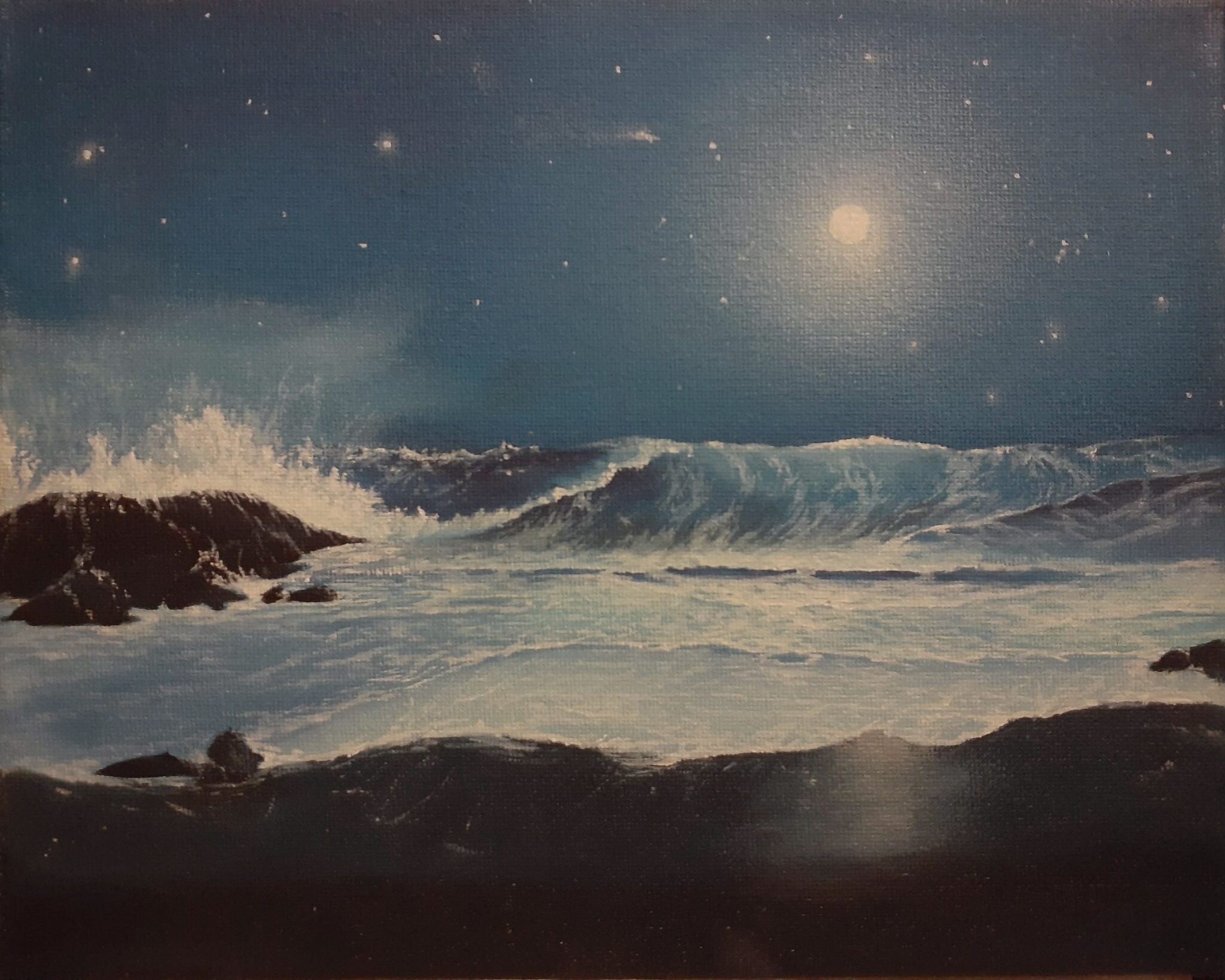 A bright moon rises over the ocean waves.
