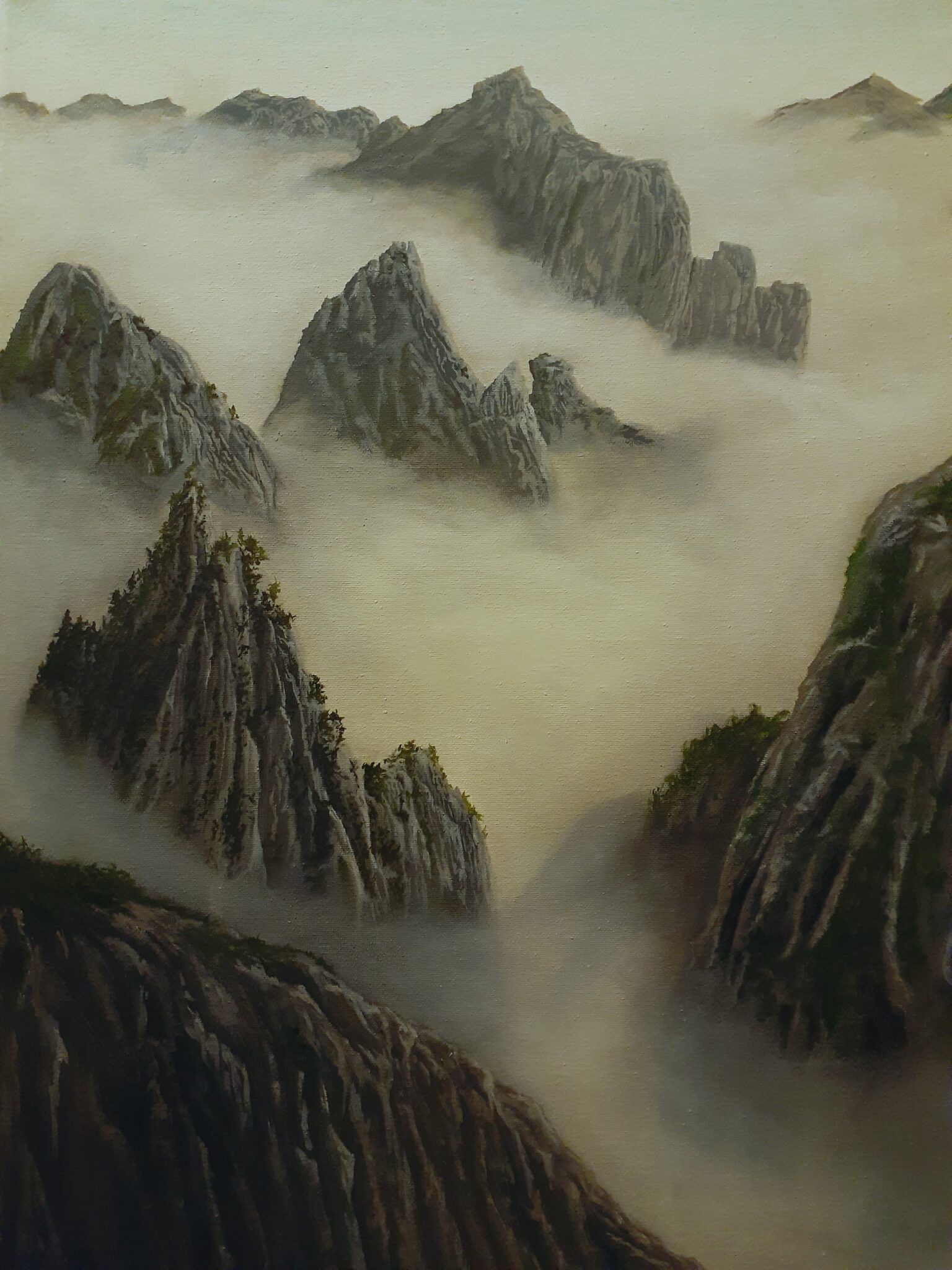 The view from a foggy lookout point. Rocky mountains are seen progressing into the distance.