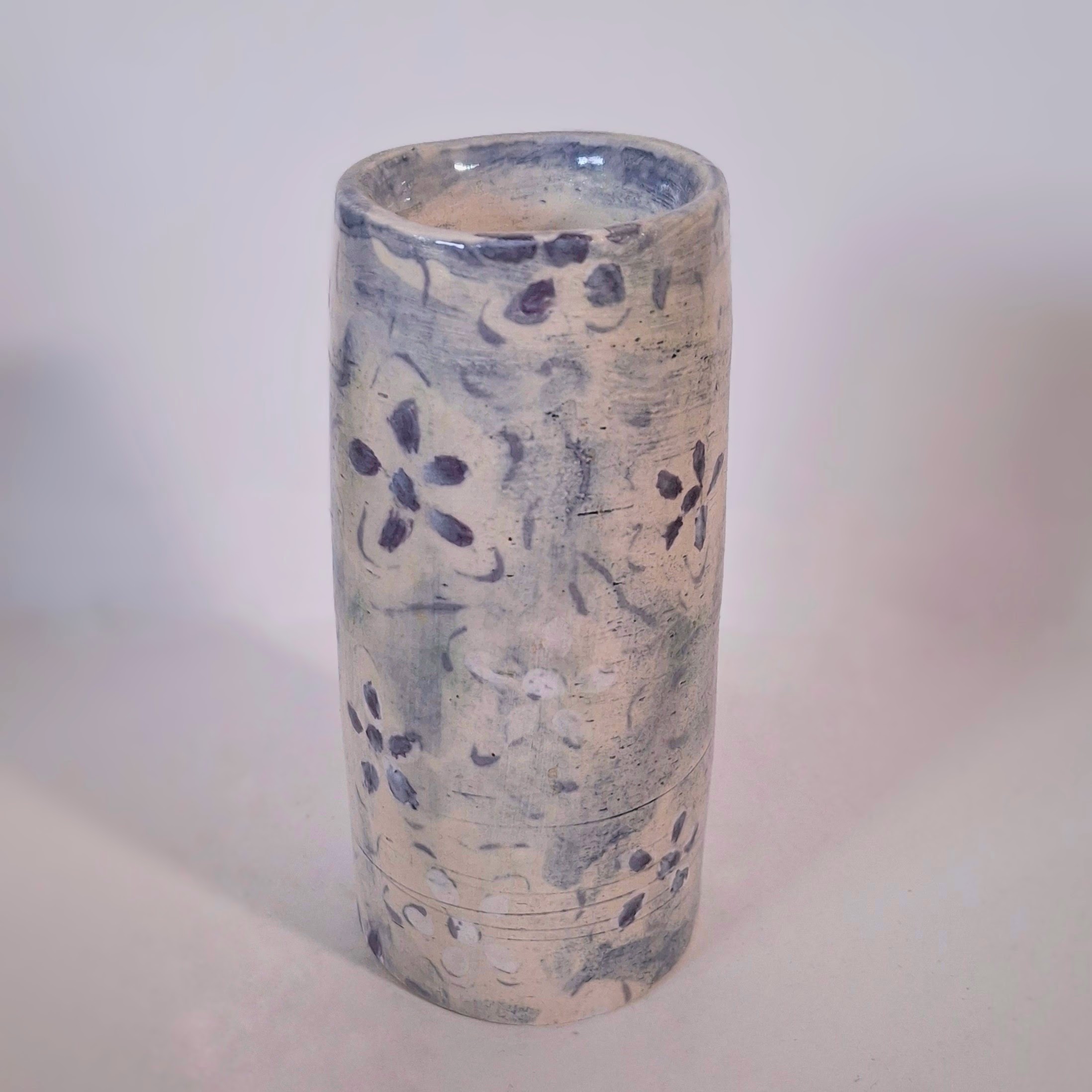 A narrow floral cylinder