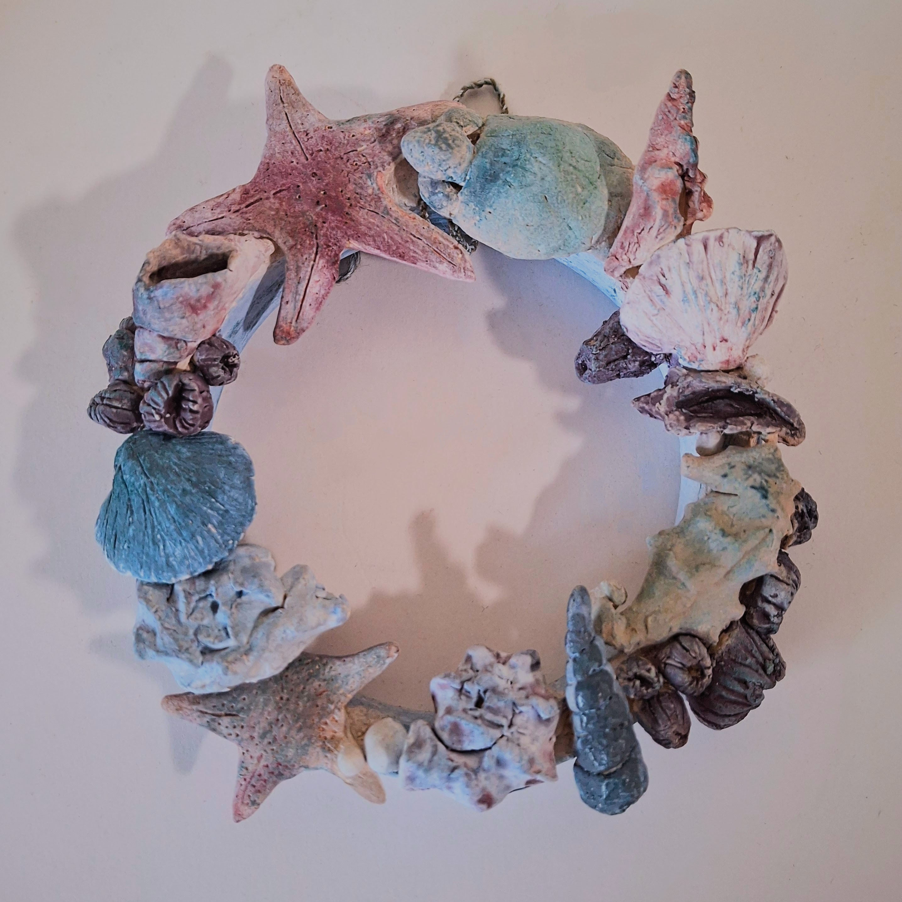 A small ceramic circle with marine motiffs.